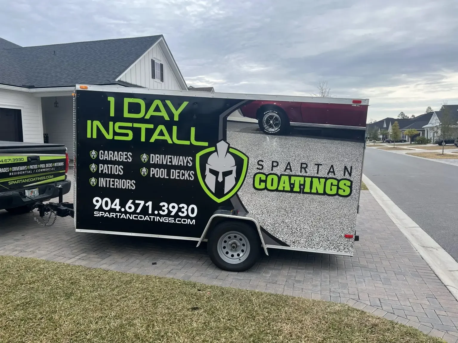Spartan Coatings trailer parked on a paver driveway at a job